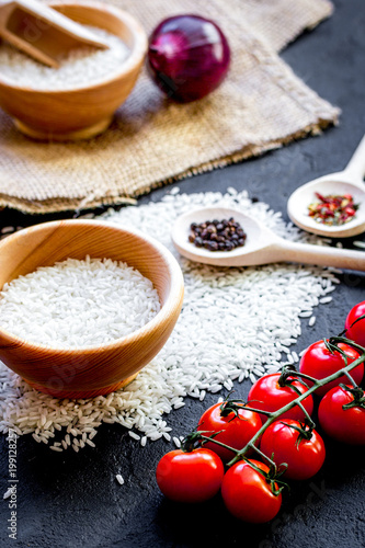 ingredients for paella on dark background