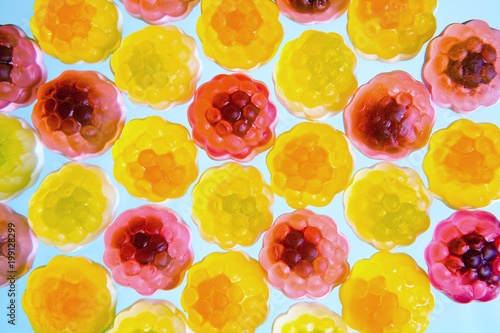 Mosaic of colorful fruit chewing marmalade.