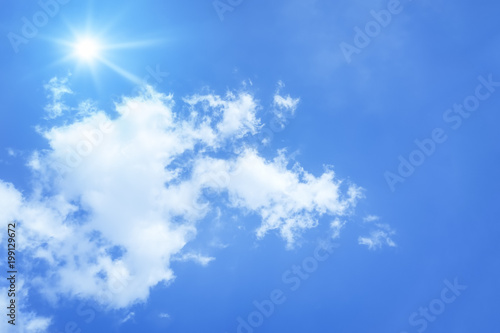 bright blue sky with sun and clouds background