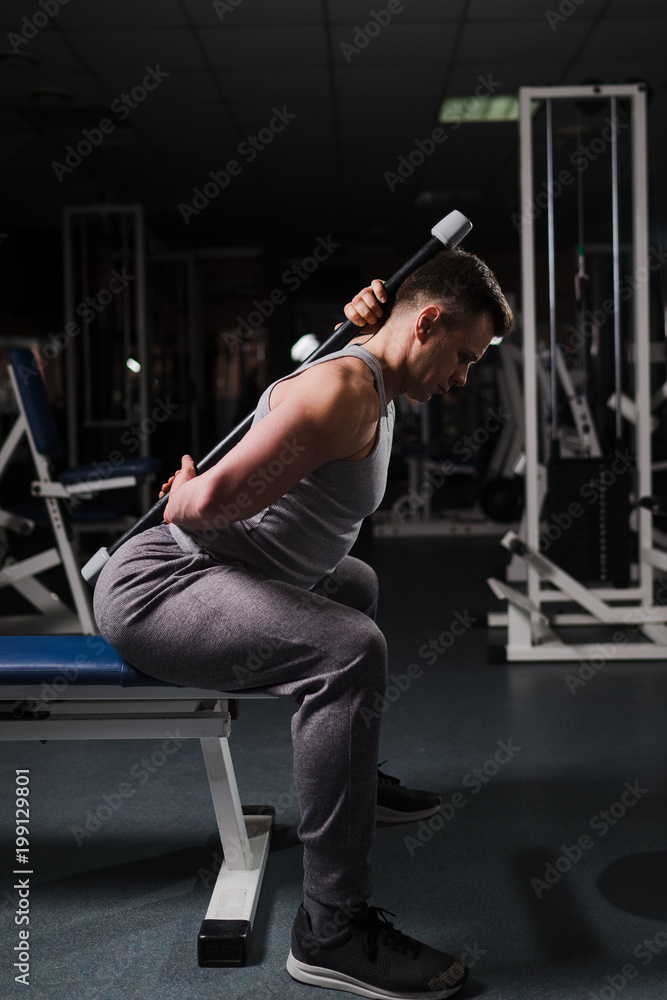 Strong handsome fit man exercising in the gym. Personal trainer workout. Athletic man working out his arms and chest muscles. Fitness, healhty lifestyle, bodybuilding concept. Strong handsome fit man exercising in the gym. Personal trainer workout. Athletic man working out his arms and chest muscles. Fitness, healhty lifestyle, bodybuilding concept.