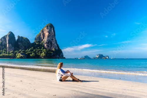 Woman resting on Railay beach Krabi Thailand. Asia