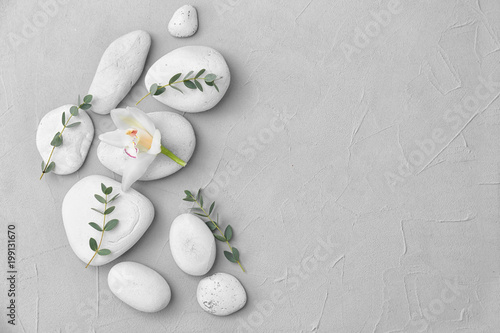 Spa stones and beautiful flower on light background