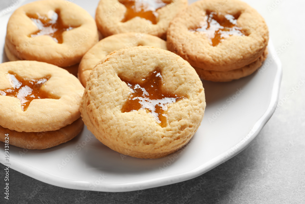 Tasty Linzer cookies with jam on plate Tasty Linzer cookies with jam on plate