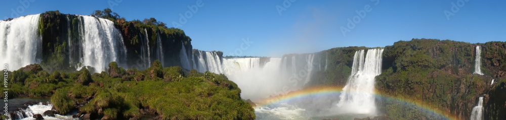 Fototapeta premium Iguazu Falls Waterfall with Rainbows and Spray as seen from the Brazil Side.