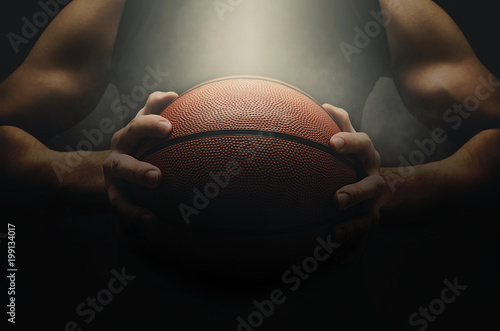Basketball player with ball over dark background
