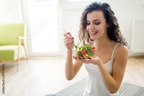 Fitness woman eating healthy food after workout