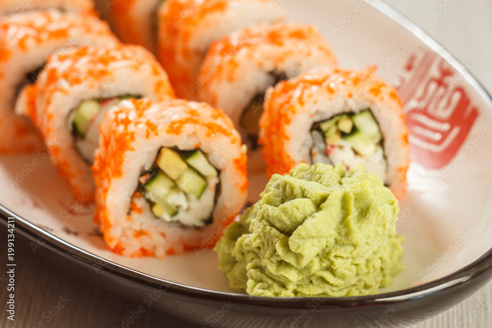 Close up wasabi and sushi rolls - Uramaki California on the plate. Japanese cuisine Close up wasabi and sushi rolls - Uramaki California on the plate. Japanese cuisine