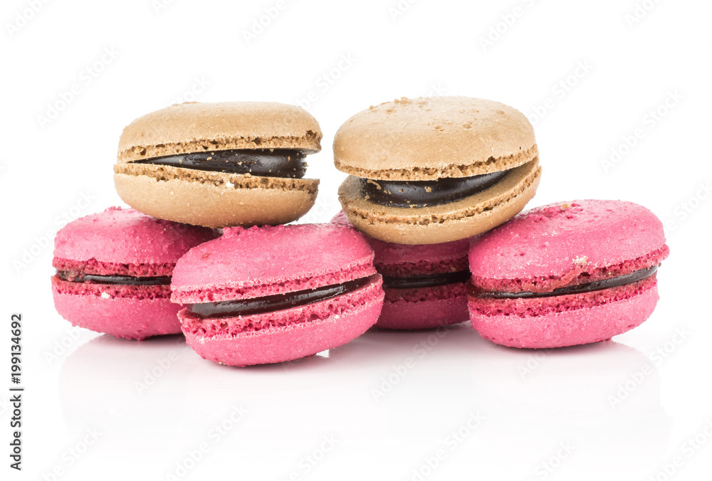 French macarons set (four pink with raspberry jam and two chocolate) isolated on white background. French macarons set (four pink with raspberry jam and two chocolate) isolated on white background.