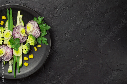 Fresh vegetables on a black plate photo