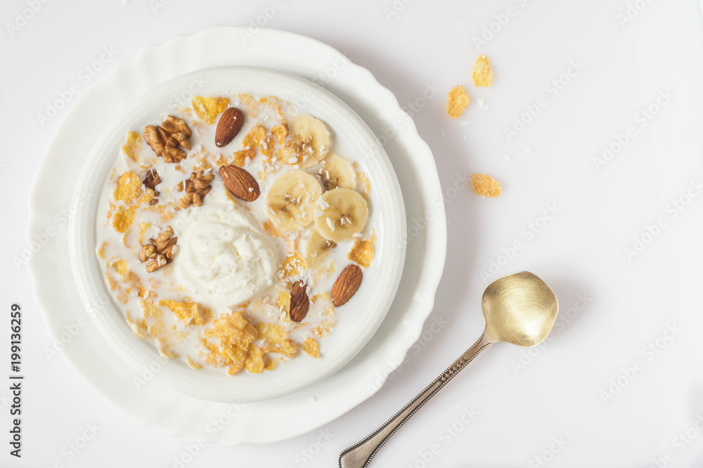 Oat flakes and nuts with milk on white plate Oat flakes and nuts with milk on white plate