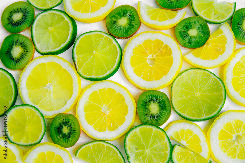 Lemon, lime and kiwi sliced slices. Fruit summer refreshing background. Lemon, lime and kiwi sliced slices. Fruit summer refreshing background.