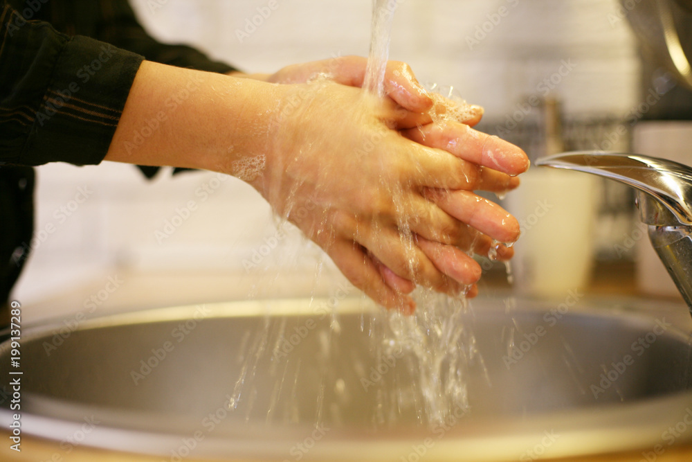 Close up of two hands getting washed. Close up of two hands getting washed.