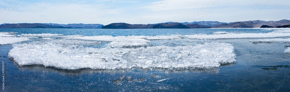 Lake Baikal in the April ice drift. Panoramic view of beautiful crystal ice floes melting in the Kurkut Gulf
