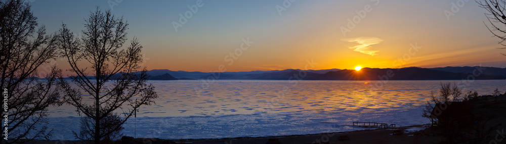 Baikal Lake in the March morning. Panorama of the sunrise over the Small Sea Strait (Maloye More)