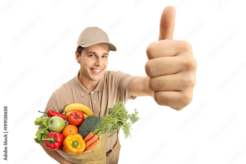 Delivery man with a bag of groceries making a thumb up gesture Delivery man with a bag of groceries making a thumb up gesture