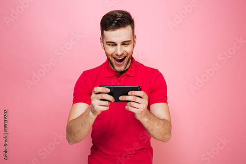 Portrait of an excited young man playing games © Drobot Dean