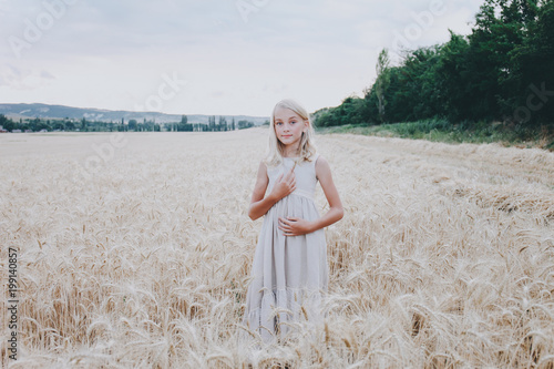 Smiling girl in a wheat field.
