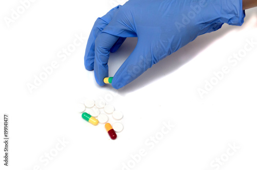 capsule with medicine in hand on a white background