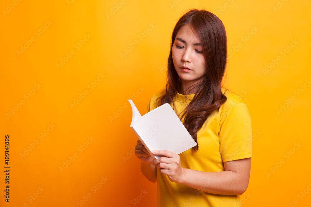 Young Asian woman read a book. Young Asian woman read a book.