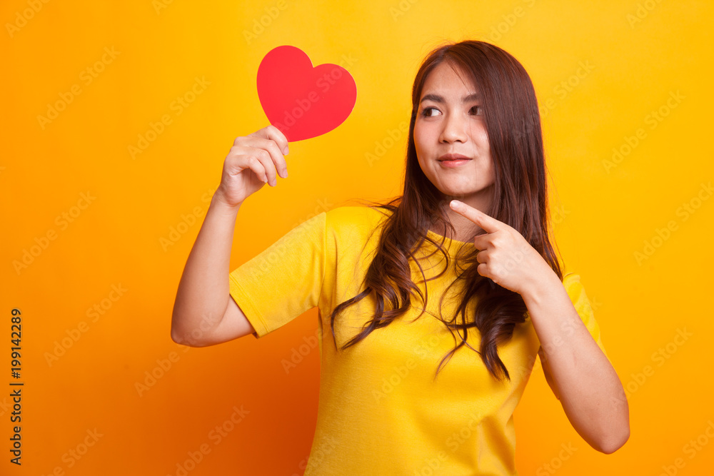 Asian woman point to red heart. Asian woman point to red heart.