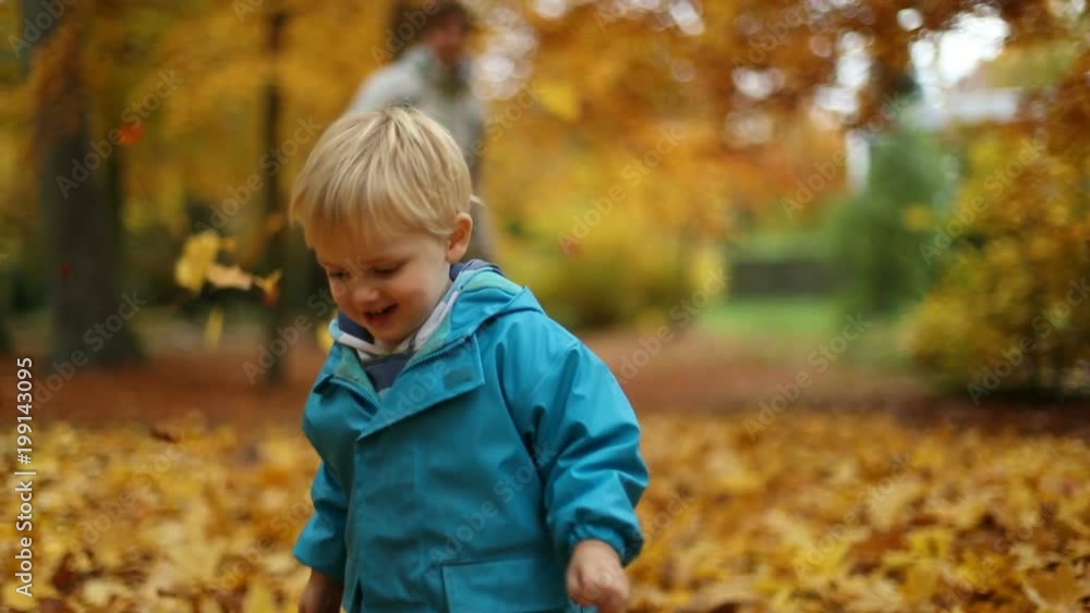 Teenager and Little Boy Playing With Autumn Leaves in Slow Motion Teenager and Little Boy Playing With Autumn Leaves in Slow Motion