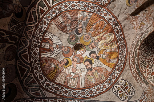 wall murals of saints and iconographic scenes, painted in naive african christian style, on wall of Abuna Yemata Guh church 