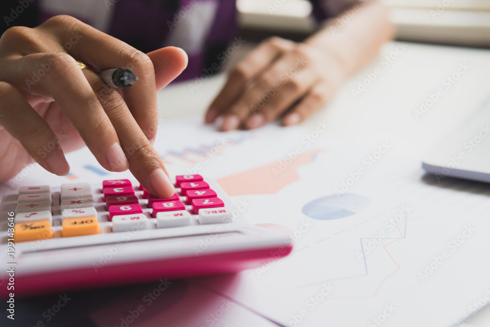 Fototapeta premium Business woman calculate about cost and doing finance at office, Finance managers task, Concept business and financial investment