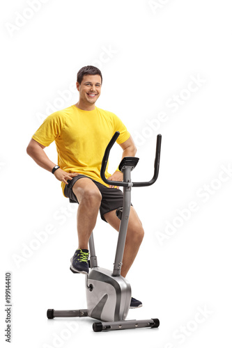Young man working out on stationary bike