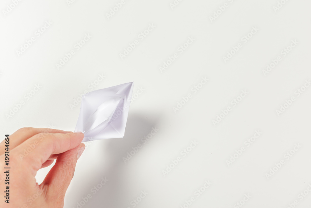 Paper ship in a female hand Paper ship in a female hand