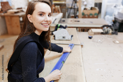 girl works in a carpenters workshop, female small business photo