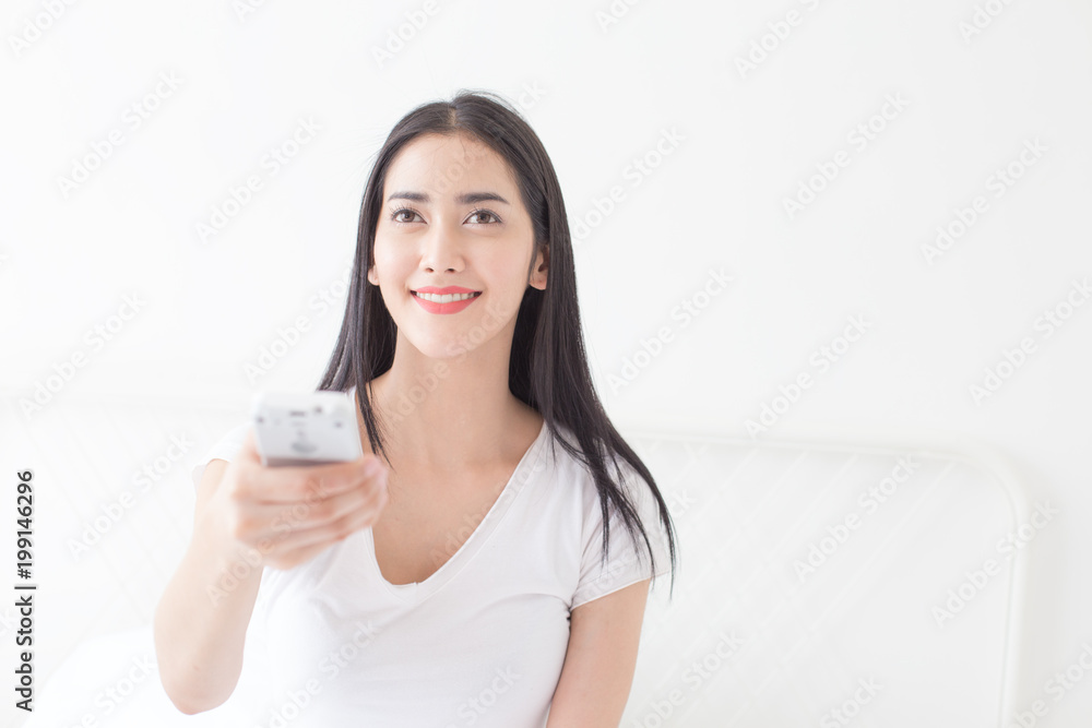 Attractive asian woman using air conditioner at home. People with lifestyle concept. Attractive asian woman using air conditioner at home. People with lifestyle concept.