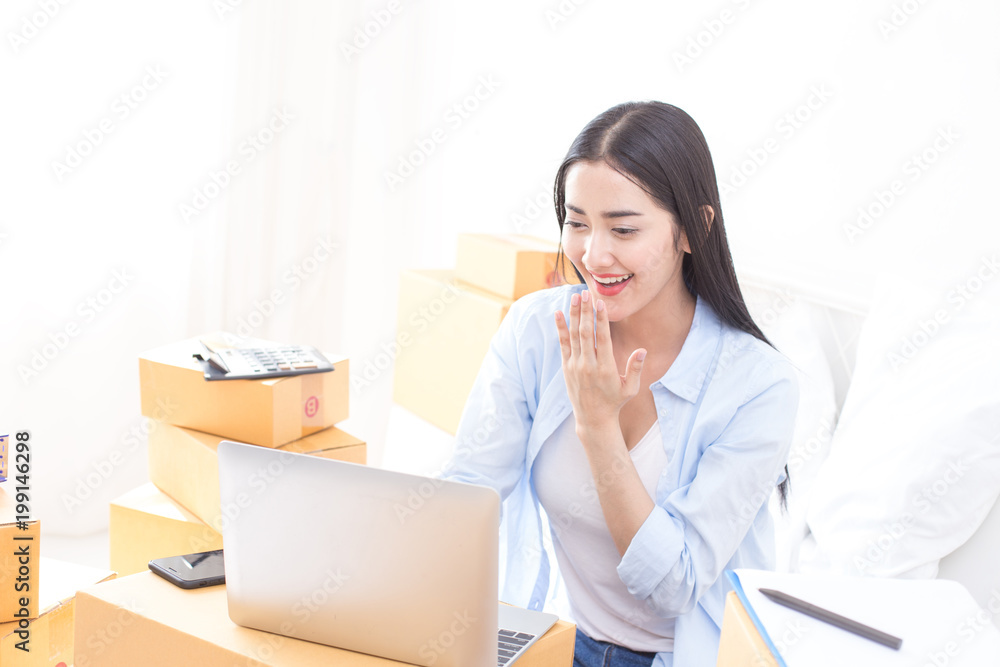 Young Asian Woman Working at home, Young Owner Woman Start up for Business Online. People with online shopping SME entrepreneur or freelance working concept. Young Asian Woman Working at home, Young Owner Woman Start up for Business Online. People with online shopping SME entrepreneur or freelance working concept.