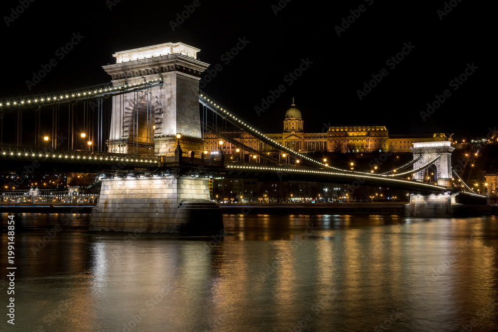 The Chain Bridge with the Royal Palace in the background in Budapest at night