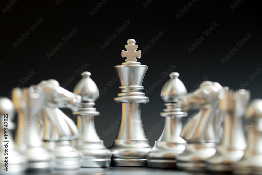 Silver king chess piece stand with bishop, knight, rook, pawn on black background (Concept for leader) Silver king chess piece stand with bishop, knight, rook, pawn on black background (Concept for leader)