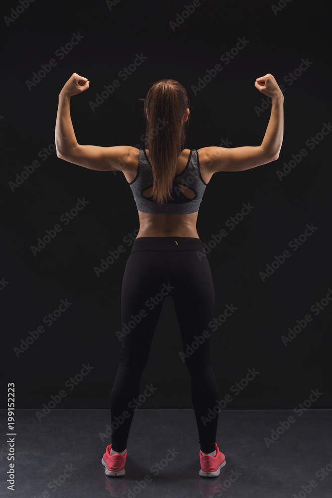 Athletic woman showing muscular body