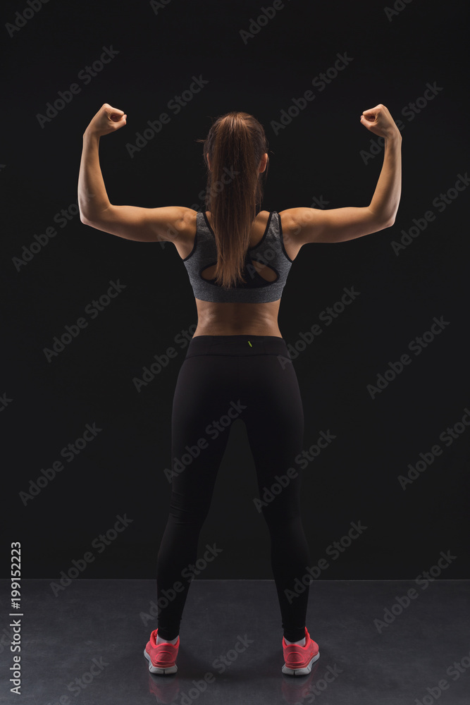 Athletic woman showing muscular body Athletic woman showing muscular body