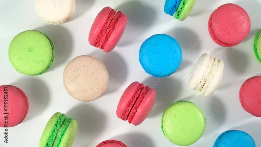 Bright Cake macaron or macaroon on white background from above, rotation colorful cookies. Top view.