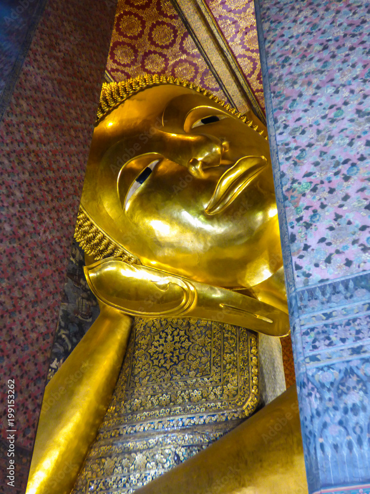 Bangkok, Thailand - Circa January 2018: Head of the big reclining Buddha at Wat Pho (Buddhist temple)