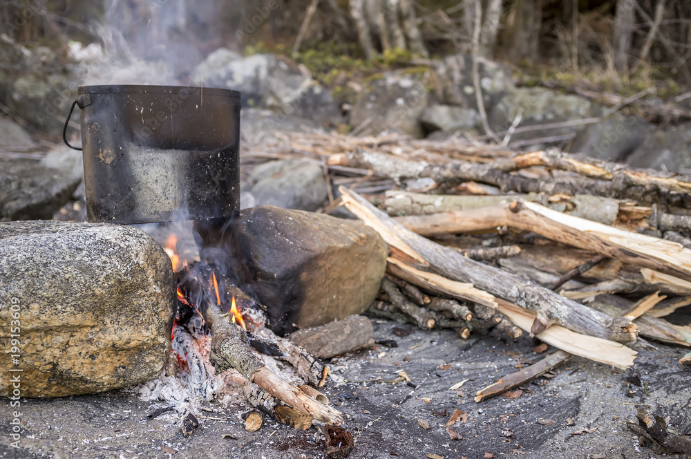 Cooking with a bowler that stands on two stones and a bonfire between them, early spring. Cooking with a bowler that stands on two stones and a bonfire between them, early spring.