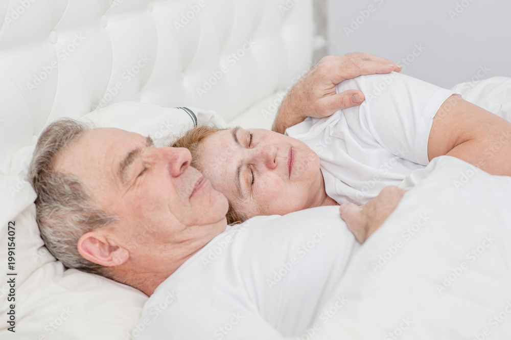elderly couple sleeping together on the bed elderly couple sleeping together on the bed