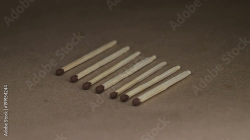 Wooden matches on craft paper rotating table