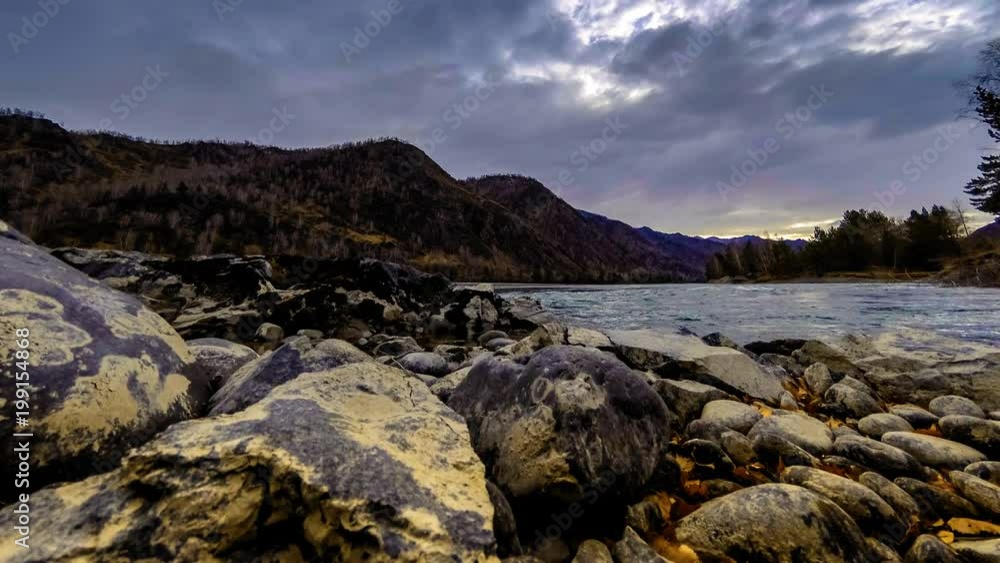4k UHD timelapse shot of the splashing water in a river near mountain forest. Huge rocks and fast clouds movenings. Horizontal movement on motorised slider dolly. 4k UHD timelapse shot of the splashing water in a river near mountain forest. Huge rocks and fast clouds movenings. Horizontal movement on motorised slider dolly.