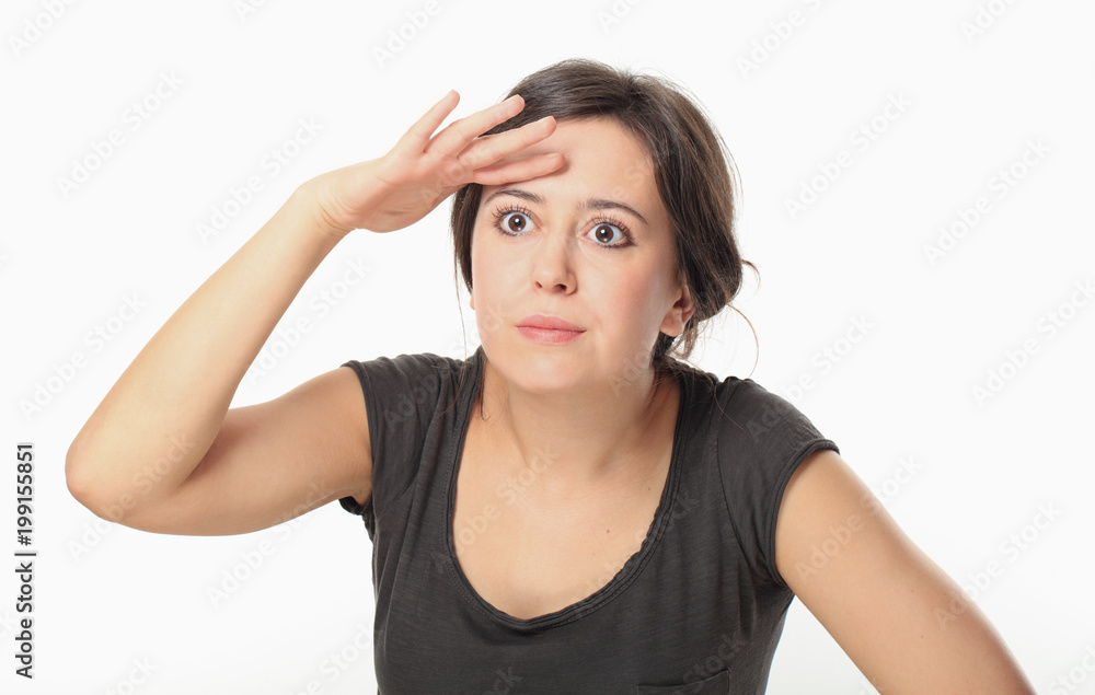 Young woman in T-shirt covering her eyes to search for something Young woman in T-shirt covering her eyes to search for something