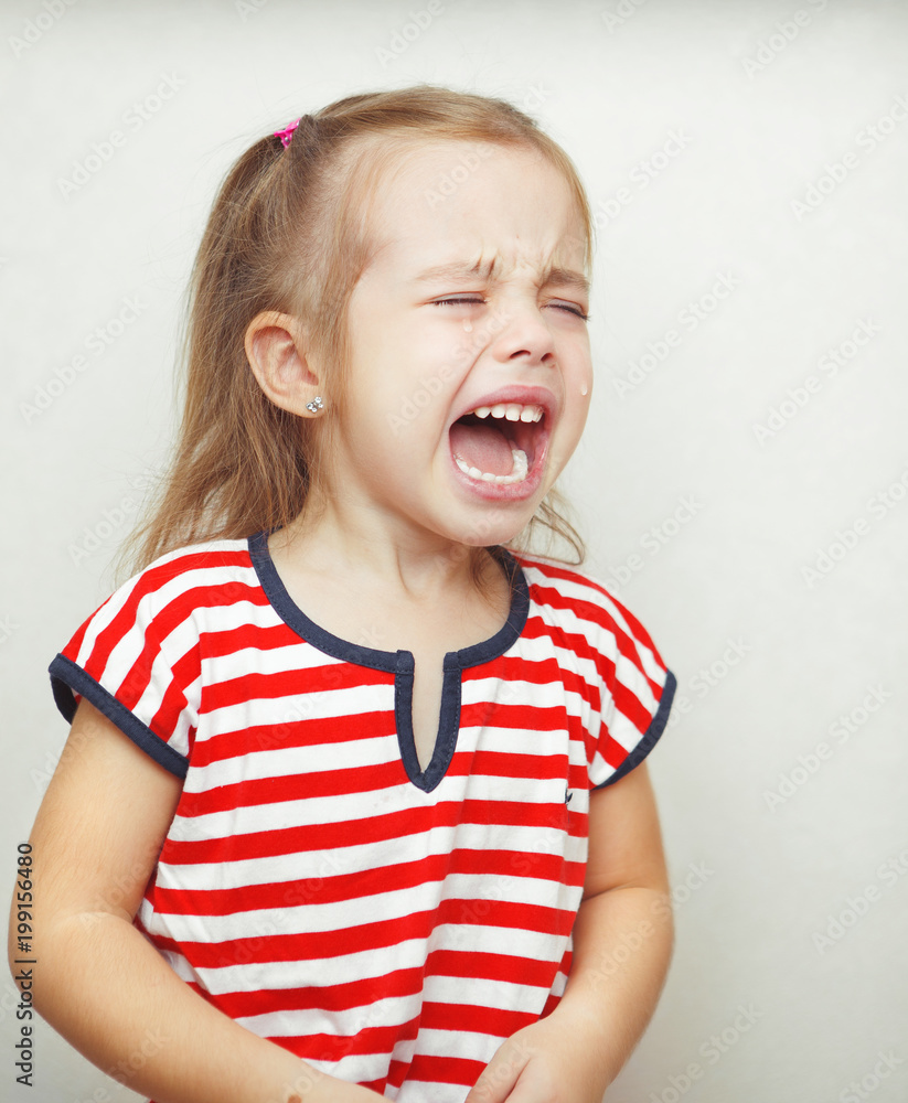 Child with tears falling down girls young face. loud cry of baby. Child with tears falling down girls young face. loud cry of baby.