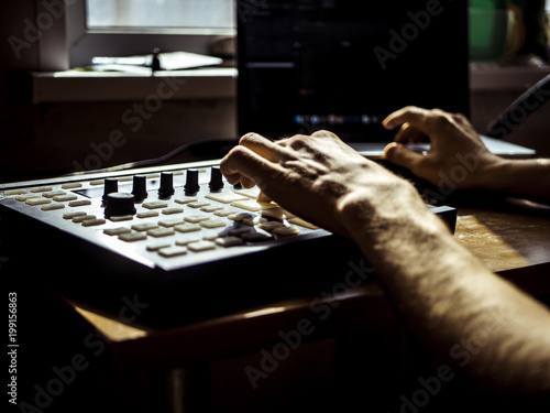 creating music at home studio on electronic drum machine with pads photo