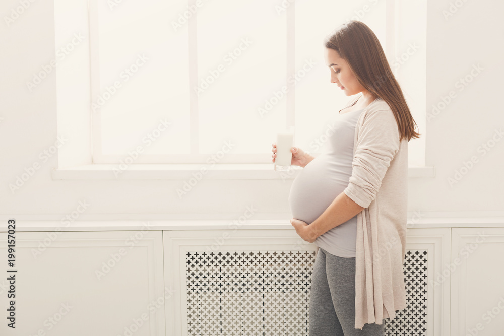 Pregnant woman with glass of milk copy space Pregnant woman with glass of milk copy space