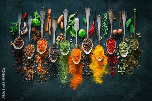 Fotografia Herbs and spices for cooking on dark background