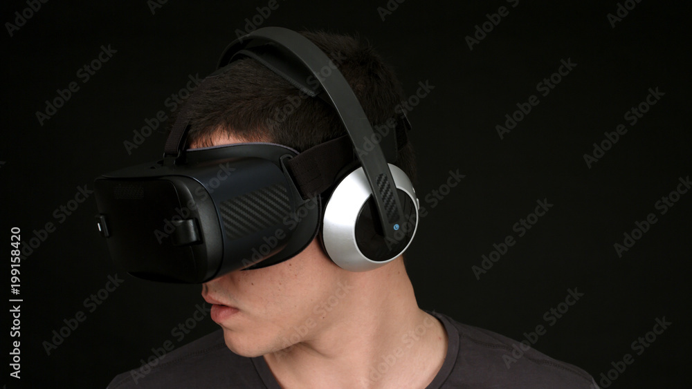 Young man wearing VR Headset and experiencing virtual reality. Young man wearing VR Headset and experiencing virtual reality.