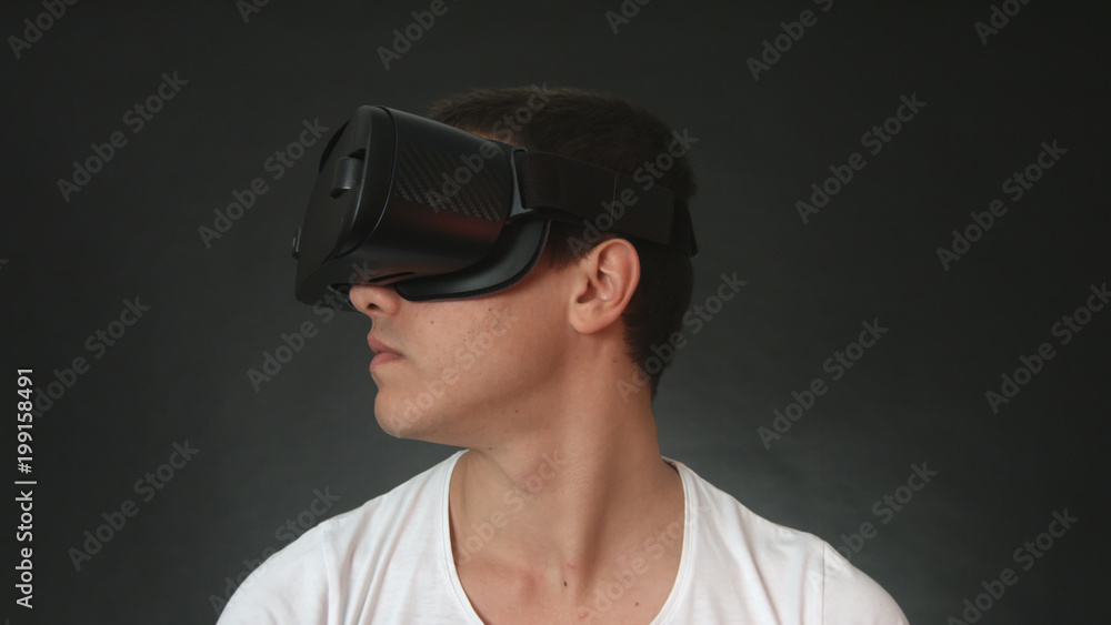 Young man wearing VR Headset and experiencing virtual reality. Young man wearing VR Headset and experiencing virtual reality.