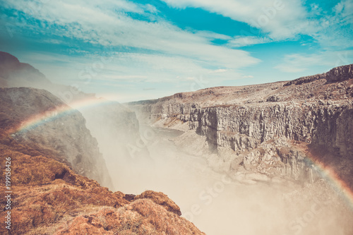 Dettifoss Waterfall in Iceland under a blue summer sky with clouds